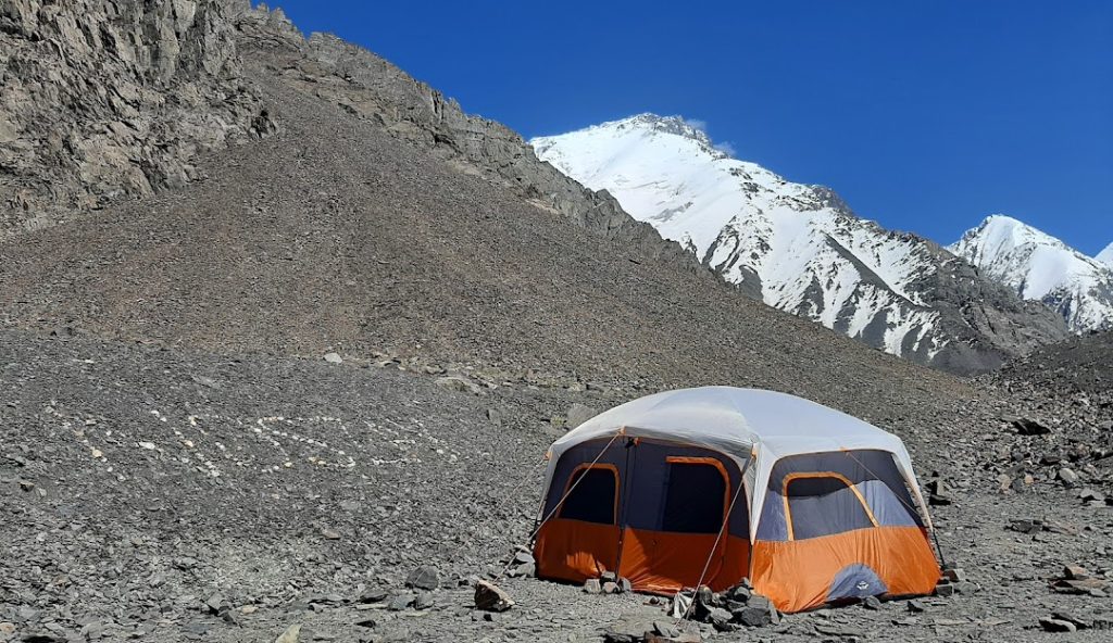 Ghandoghoro Peak, Hushe Valley, Gilgit-Baltistan, mountain expedition, trekking, alpine landscape, snow-capped peaks, adventure, Himalayas, northern Pakistan, mountaineering, scenic view, rugged terrain, outdoor adventure, traditional village